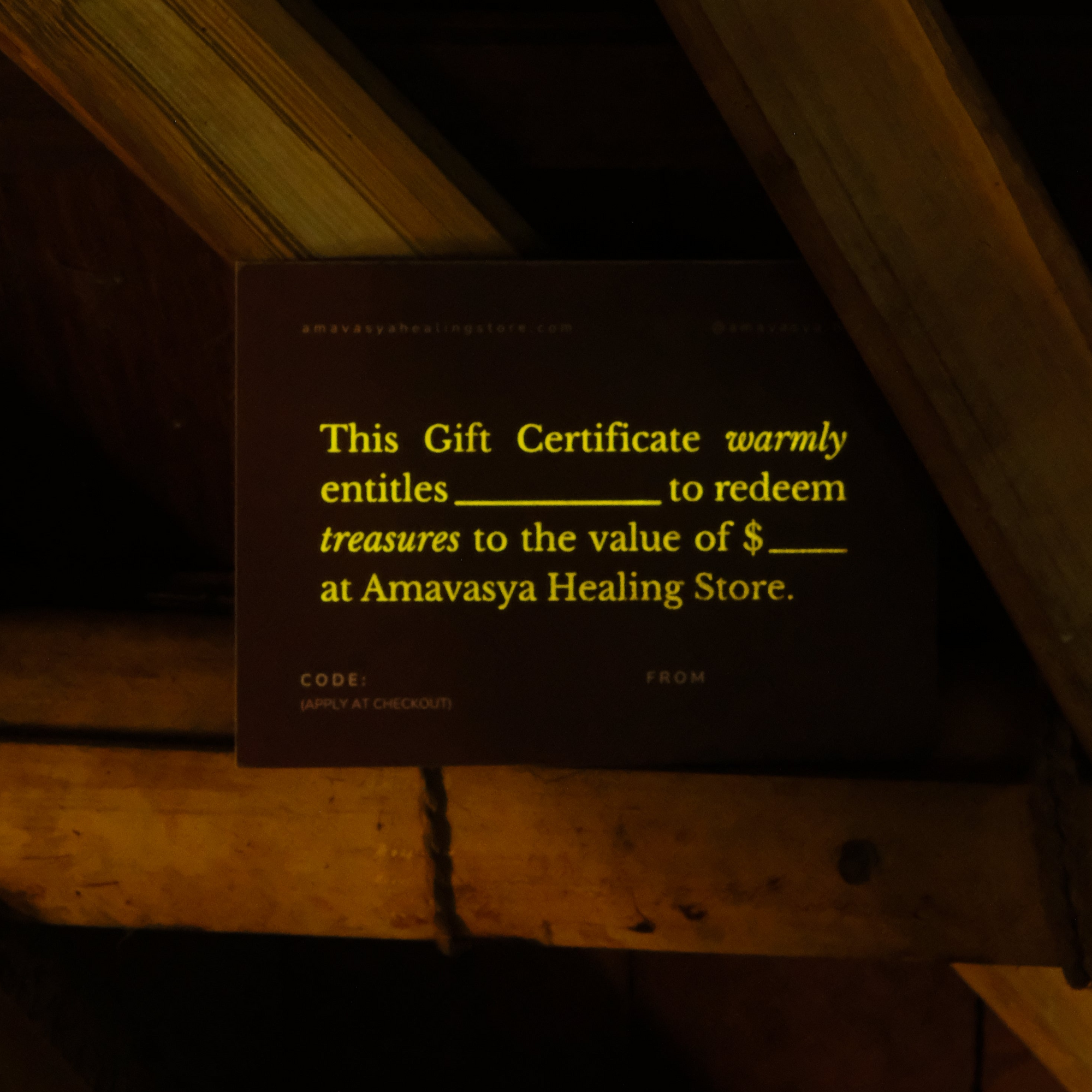 Dark gift certificate on wooden surface with yellow text
